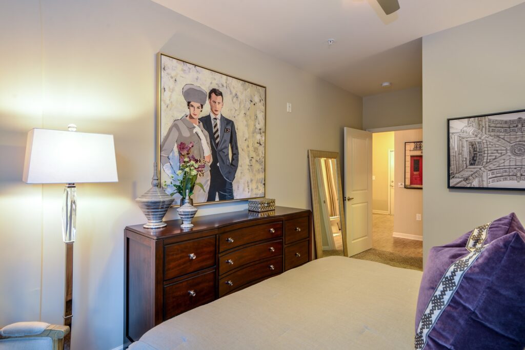 Bedroom with carpet floor, ceiling fan, and view of hallway