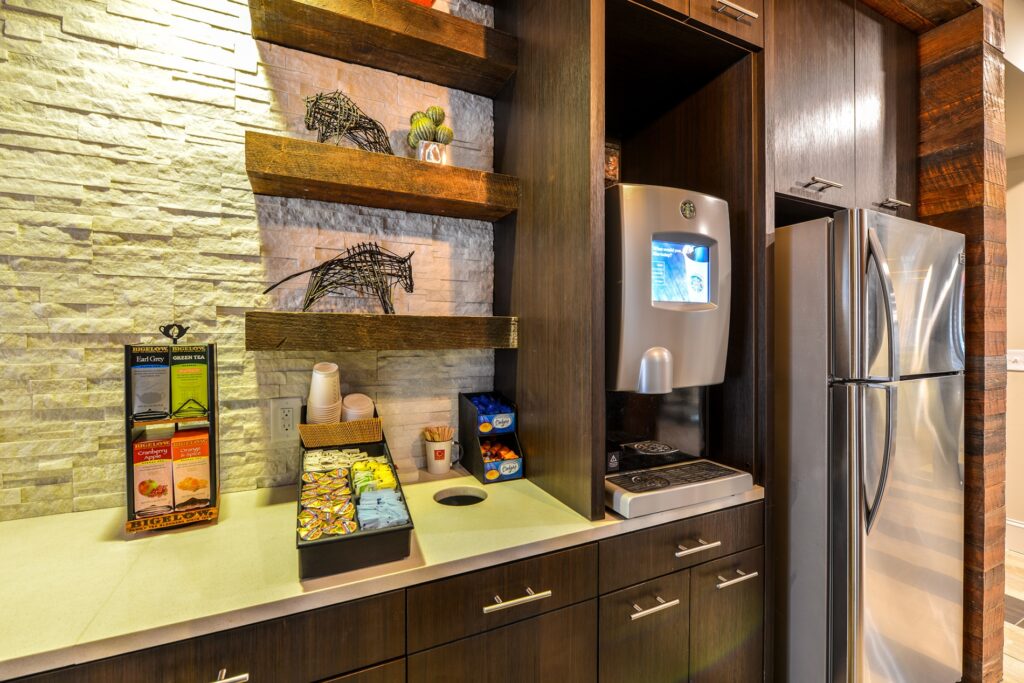 Club house kitchen area with coffee machine and fridge