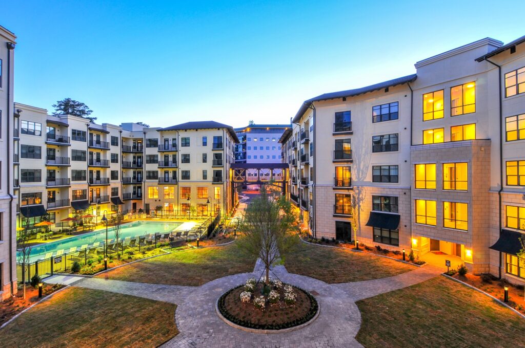 Residential courtyard with walkways and view of gated pool.