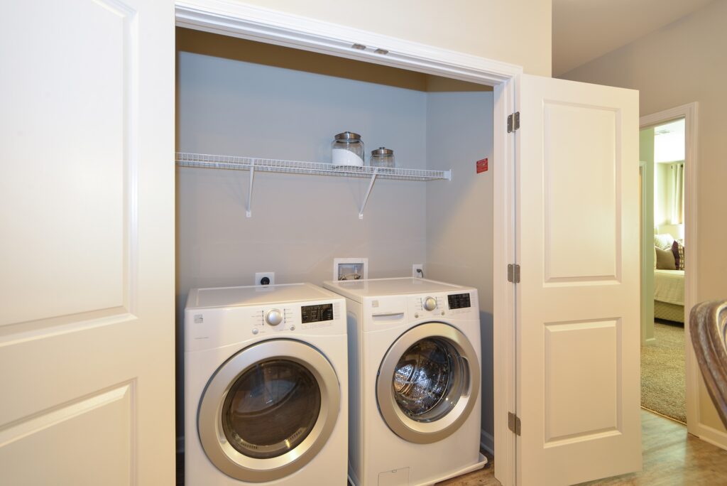 Laundry room with washer and dryer with shelf built in
